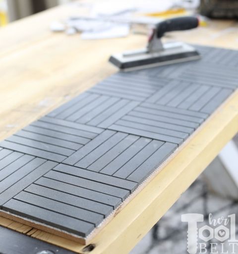 a close up of a table with a mop on top of it and some construction materials in the background