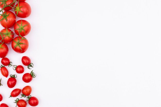 tomatoes are scattered around on a white surface