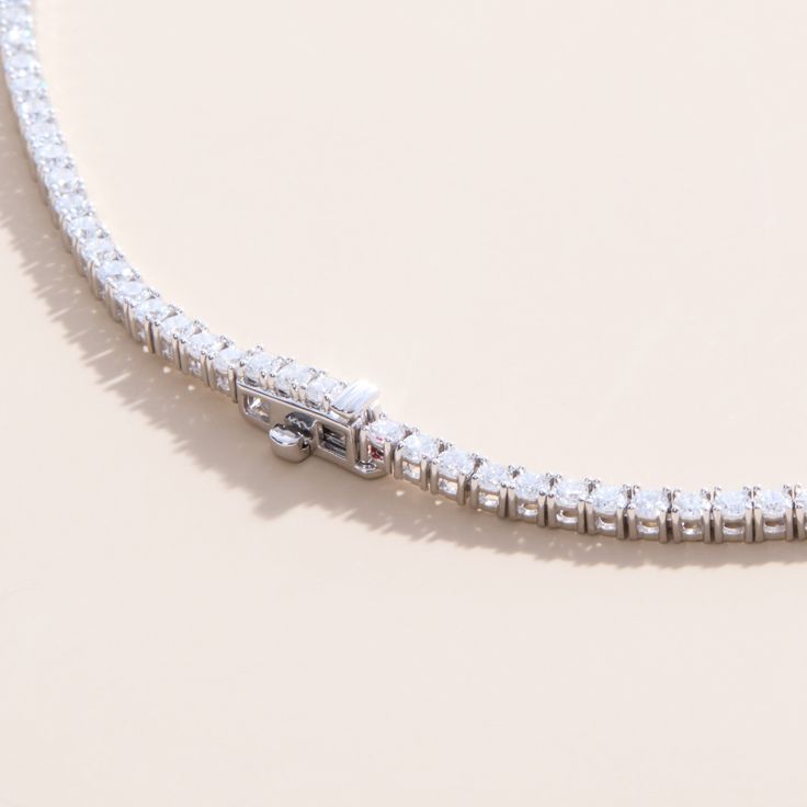 Callie Embrace modern elegance with our Lab Grown Diamond Tennis Necklace. This stunning piece features a continuous line of sparkling lab-grown diamonds, each meticulously set in a sleek and timeless design. Perfect for any occasion, this necklace offers the brilliance of diamonds with an eco-friendly touch. Whether you're dressing up for a special event or adding a touch of luxury to your everyday look, this tennis necklace is a versatile and sophisticated addition to your jewelry collection. Luxury Lab Grown Diamond Tennis Necklace For Formal Events, Timeless Sterling Silver Tennis Necklace With Round Cut, White Gold Tennis Necklace With Lab Grown Diamonds, Timeless Sterling Silver Tennis Necklace, Timeless Tennis Necklace With Brilliant Cut Cubic Zirconia, Elegant Round Lab Grown Diamond Tennis Necklace, Elegant Round Tennis Necklace With Lab Grown Diamonds, Fine Jewelry Tennis Necklace With Brilliant Cut Cubic Zirconia, Formal White Gold Cubic Zirconia Tennis Necklace