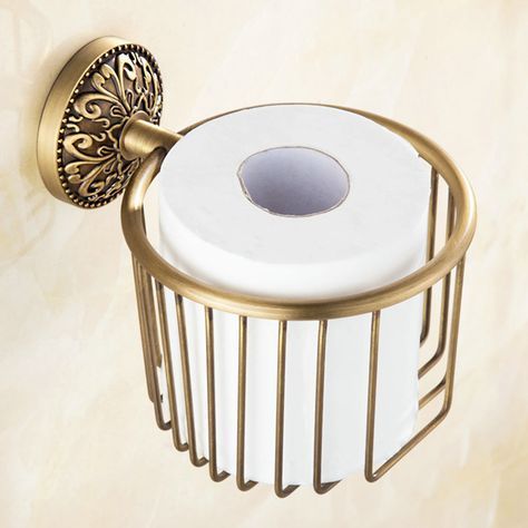 a gold toilet paper holder with a roll of toilet paper on the front and side