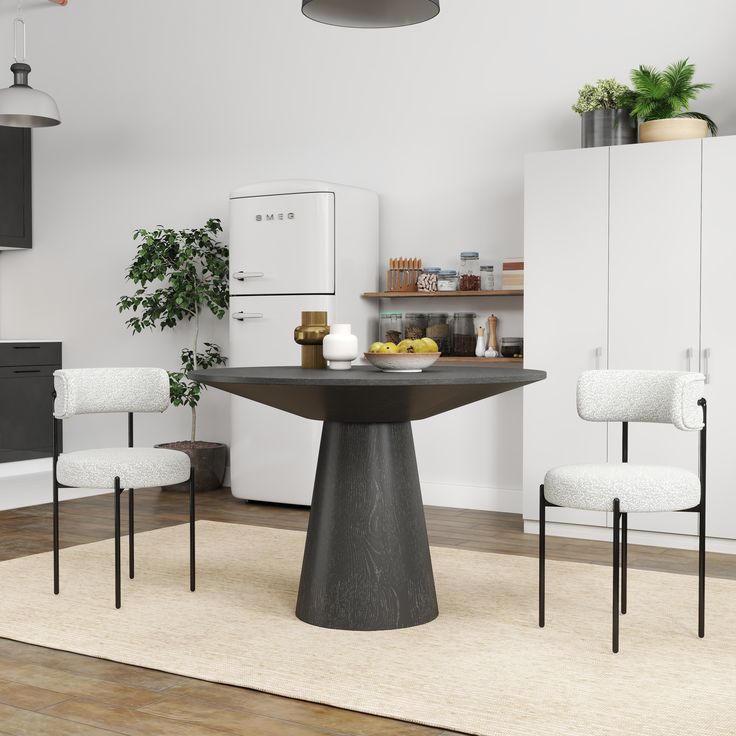 a dining room table with two chairs and a potted plant in the corner next to it