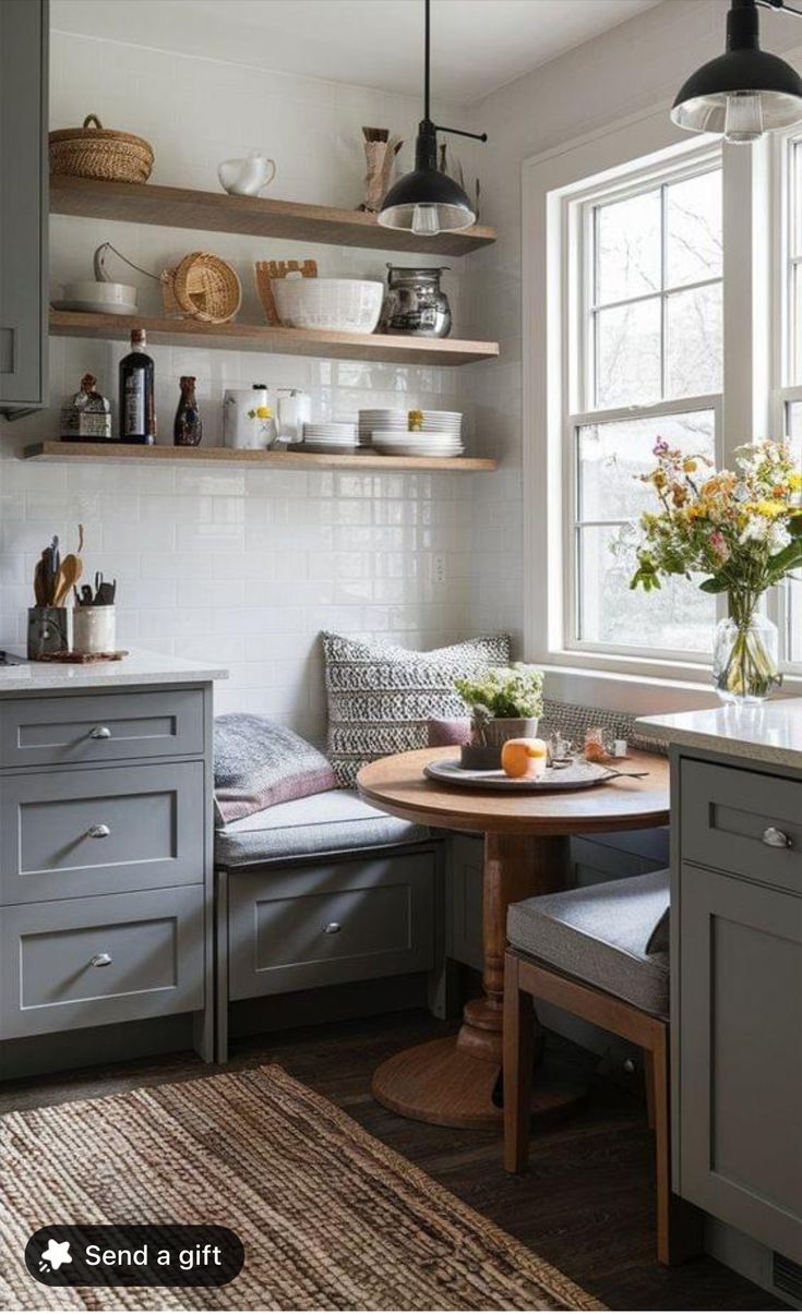 a kitchen with gray cabinets and shelves filled with dishes on top of the cupboards