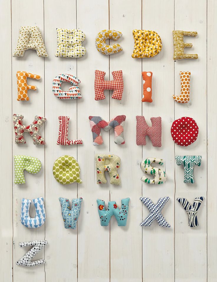 the letters are made out of fabric and have different designs on them, including polka dots