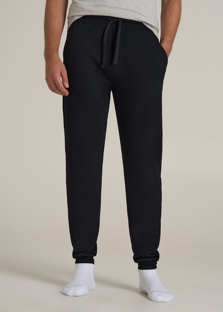 Sleep Tight in Right-Sized Tall Men's Jogger Pants For Tall Guys Who Dream Big Say goodnight to high-water pajamas and hello to our Sleep Joggers for Tall Men, where comfort meets length to fit like a dream. Designed specifically for taller guys, these extra-long men's joggers offer full-length coverage, an elastic waist with an internal drawstring, and a relaxed fit that’s just right for winding down. The soft fabric ensures you stay comfortable all night long, while the practical pockets mean Say Goodnight, Scrubs Dress, Cozy Sleepwear, Mens Jogger Pants, Tall Men, Men In Black, Summer Lookbook, Sleep Tight, High Water