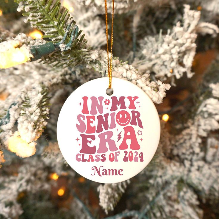 a personalized ornament hanging from a christmas tree