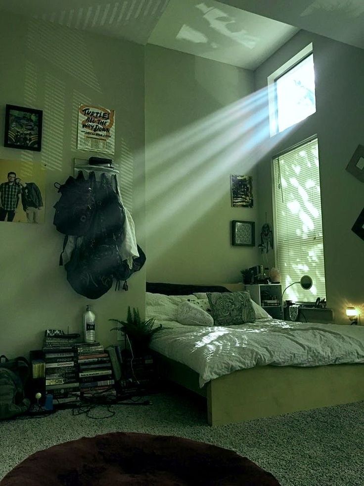 a bed room with a neatly made bed and lots of pictures hanging on the wall