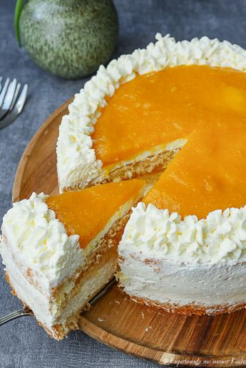 a cheesecake on a wooden plate with one slice cut out and the other half eaten