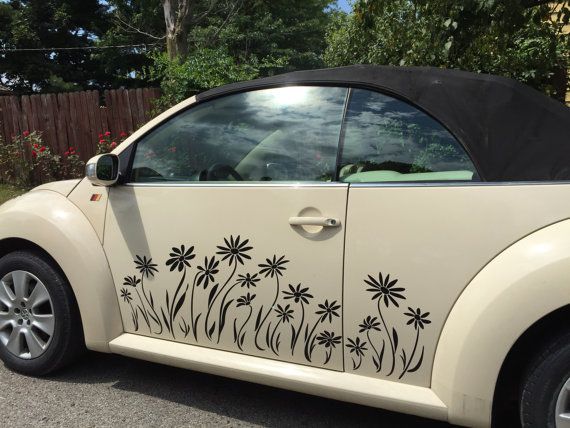 a white car with flowers painted on it's side