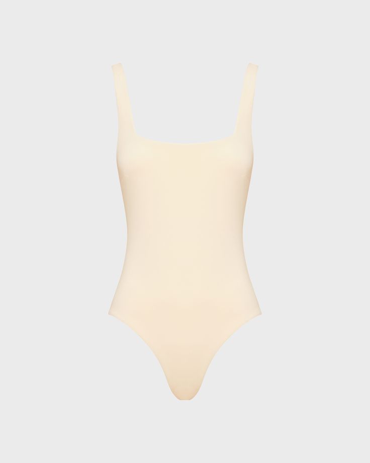 Margot one piece in Porcelain is a timeless classic swimsuit has an elegant square neckline front and back and invisible under-bust support. Self-lined in our ultra-soft Embodee™ fabric that has high shaping power, gently holding, shaping and enhancing the silhouette. To ensure the garment is opaque when wet, the front of the suit is a triple layer. A beautiful, classic one piece that will show off your summer tan and in a soft, matte fabric works perfectly as a body suit worn under skirts, shorts and pants. Luxury fabric sustainably made in Italy.Garment sustainably and ethically made in Australia. Classic Swimsuit, Summer Tan, Matte Fabric, Summer Tanning, Luxury Fabric, Designer Swimwear, Body Suit, Luxury Fabrics, Timeless Classic