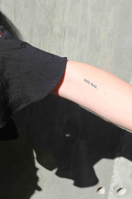 a person's arm with a small tattoo on the left side of their arm