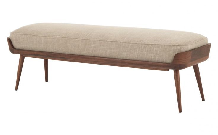 an upholstered bench with wooden legs and a cushion on the seat, against a white background