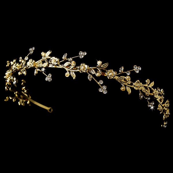 a gold tiara with white flowers and leaves on it's headband, against a black background