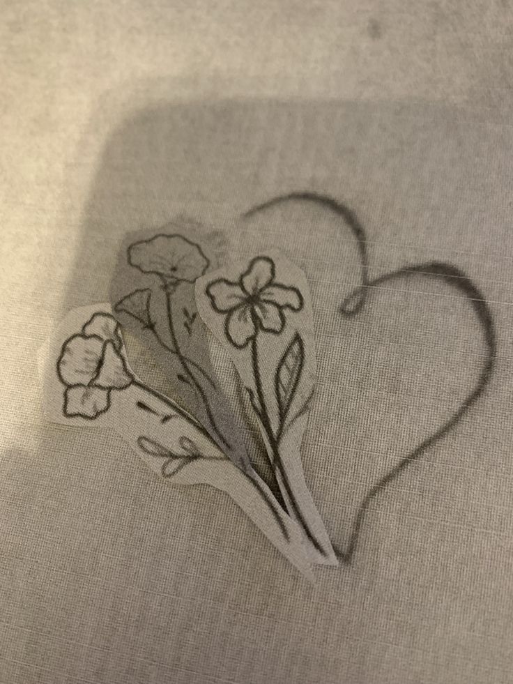 a heart shaped cutout with flowers on it