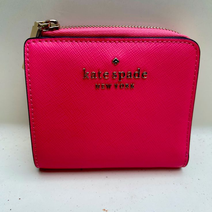 Type: Kate Spade Wallet Style: Fashionable Color: Pink Bag Size: Small Material: Leather All Sales Final! New With Tags Pink Kate Spade Wallets With Card Slots, Compact Kate Spade Wallets As Gifts, Compact Kate Spade Wallet, Kate Spade Pink Bifold Wallet, Chic Pink Wallet With Zipper Closure, Pink Rfid Blocking Bags, Pink Rfid Blocking Wallet, Kate Spade Pink Wallet For Everyday Use, Kate Spade Everyday Bifold Bag