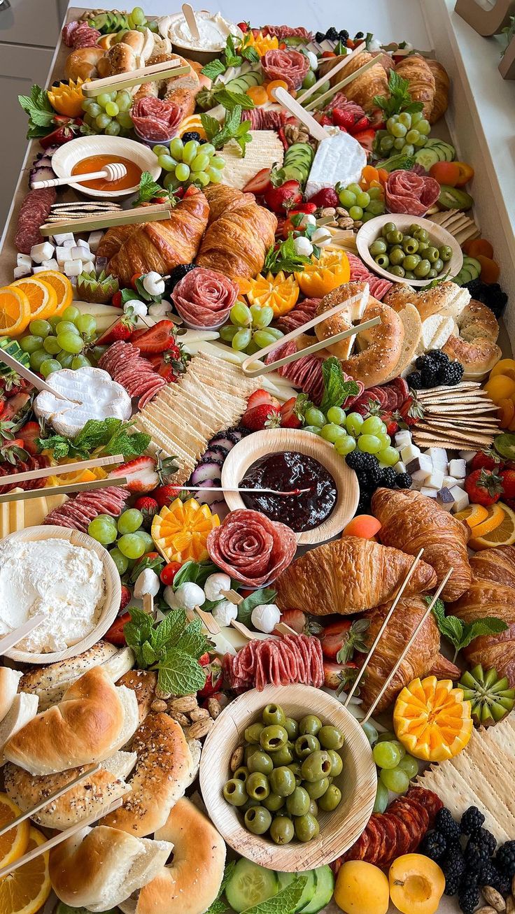 a long table filled with lots of different types of food on sticks and plates next to each other