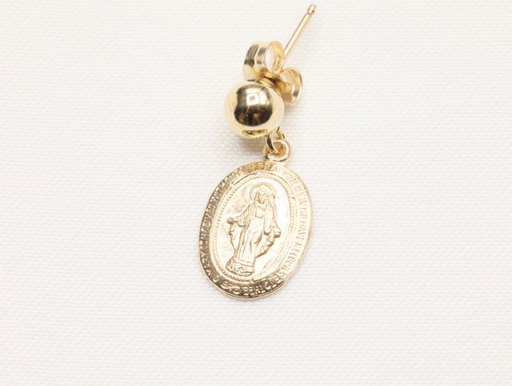 14k Gold Filled Virgin Mary Earrings / Miraculous Earrings / Catholic Jewelry / Gold Coin Jewelry / Catholic Gifts - 9 x 13mm Gold Filled Virgin Mary Pendant - Front design: Mama Mary - Back design: letter M with a cross on top and scattered stars - 14k Gold Filled 5mm stud - Sold as a pair - Tarnish free, hypoallergenic, nickel free and safe for sensitive skin 💰 We guaranteed fair pricing on all our jewelry. 🍃 All our jewelry comes with a modern style packaging, which includes a classy suede Yellow Gold 14k Charm Earrings, 14k Yellow Gold Earrings With Charms, Gold Drop Earrings With Charms, 14k Gold Filled Charms Drop Earrings, 14k Gold Filled Drop Earrings With Charms, Yellow Gold Charm Earrings For Gift, Yellow Gold Charm Drop Earrings, 14k Gold-filled Oval Earrings, 14k Gold Charm Earrings For Gifts