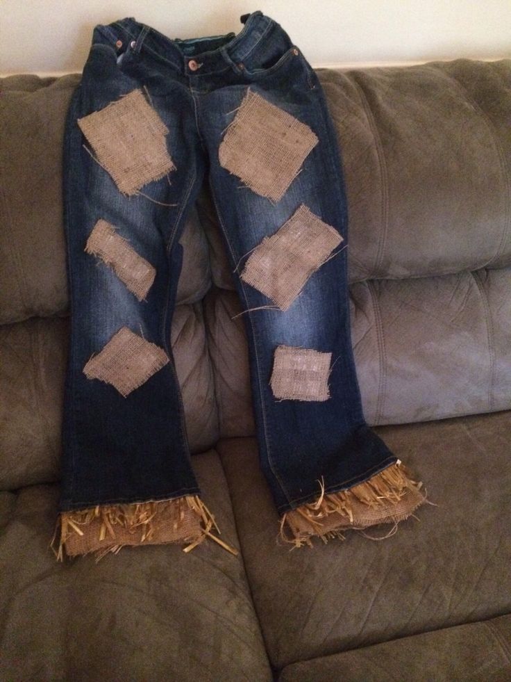 the jeans have been ripped and are sitting on the couch