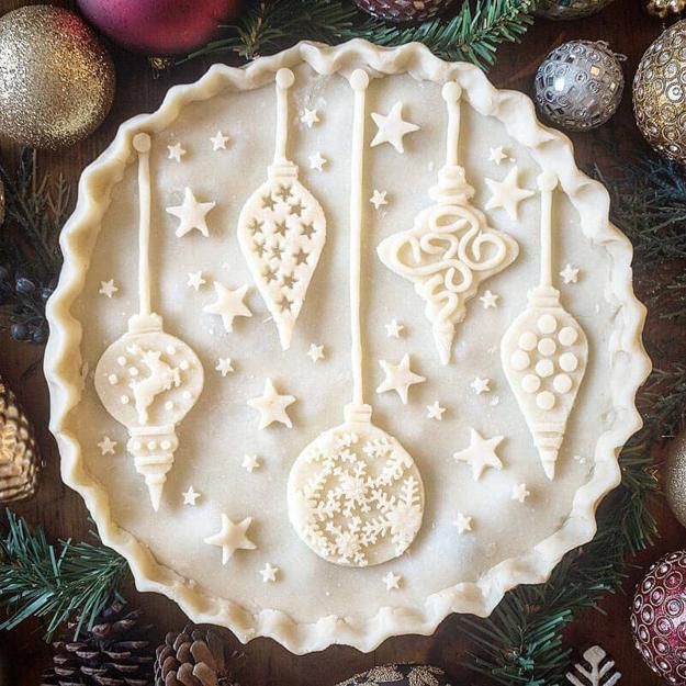 an elaborately decorated christmas pie with ornaments on it