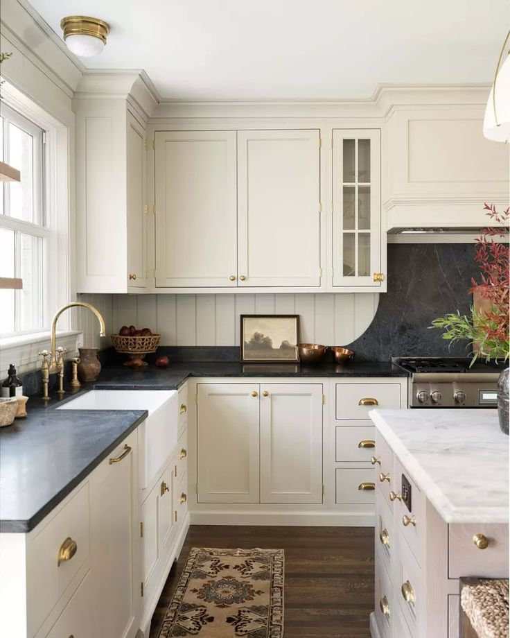 a kitchen with white cabinets and black counter tops is featured on instagram for $ 350