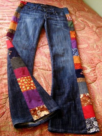 pair of jeans with colorful patchwork on bed