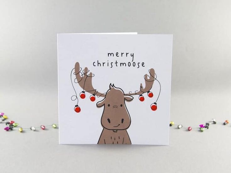 a merry christmas card with a moose and reindeer antlers on it's head