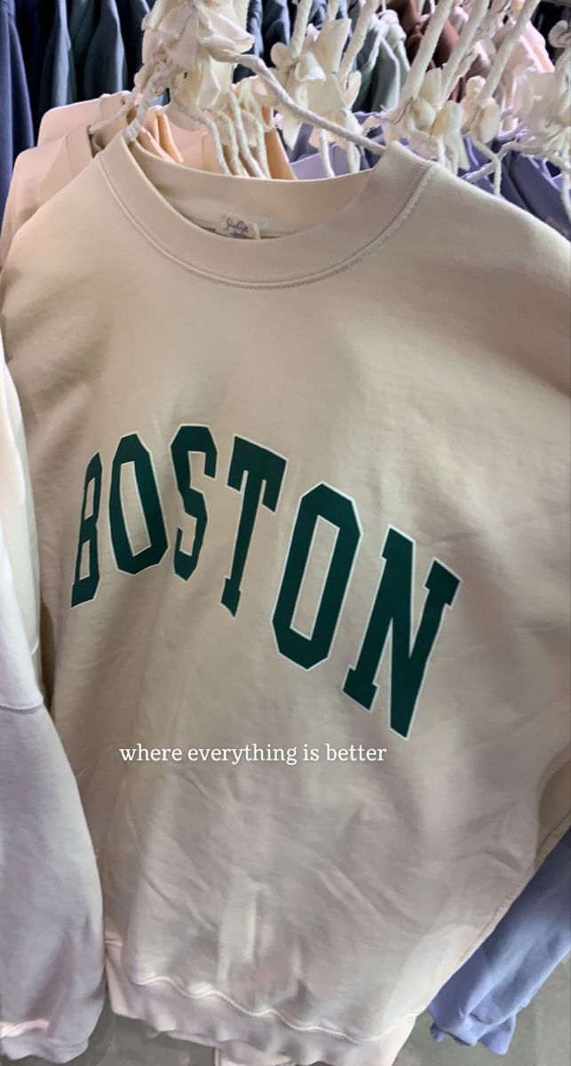 boston sweatshirts hanging on clothes rack in store