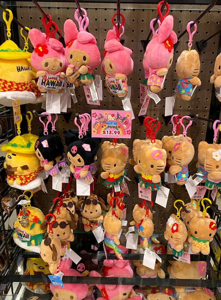 many stuffed animals are on display for sale in a toy store with price tags attached to them