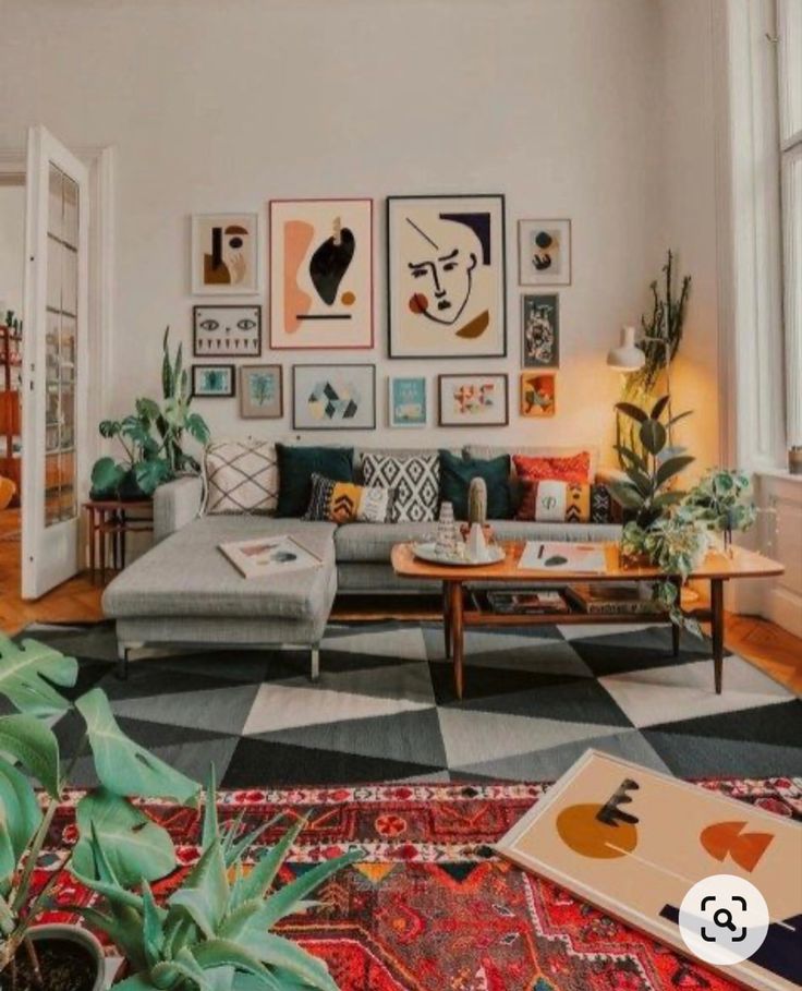 a living room filled with lots of furniture and pictures on the wall above it's coffee table