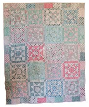 an old quilt is displayed on a white background with pink, blue and green squares