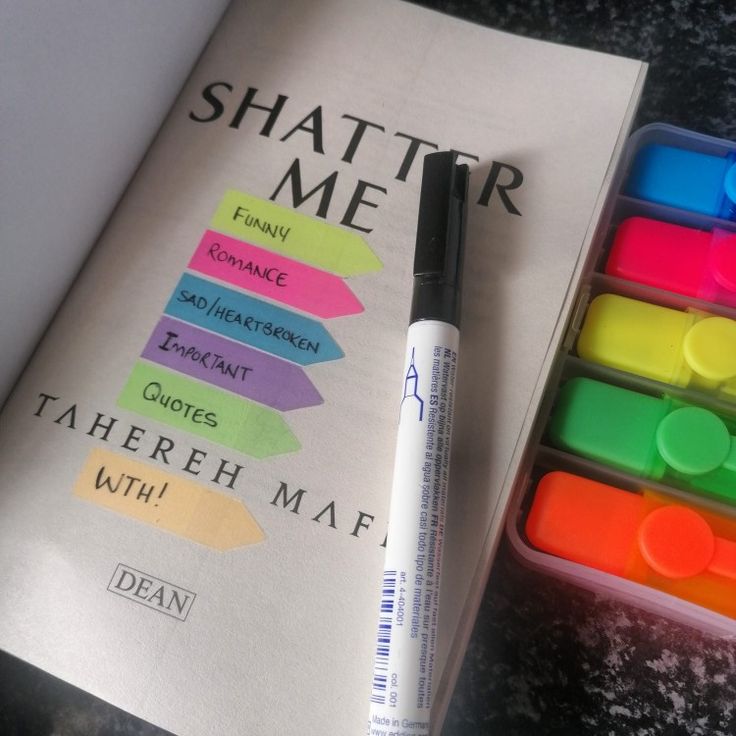 there is a book with markers on it and a pen next to it that says, shatter me