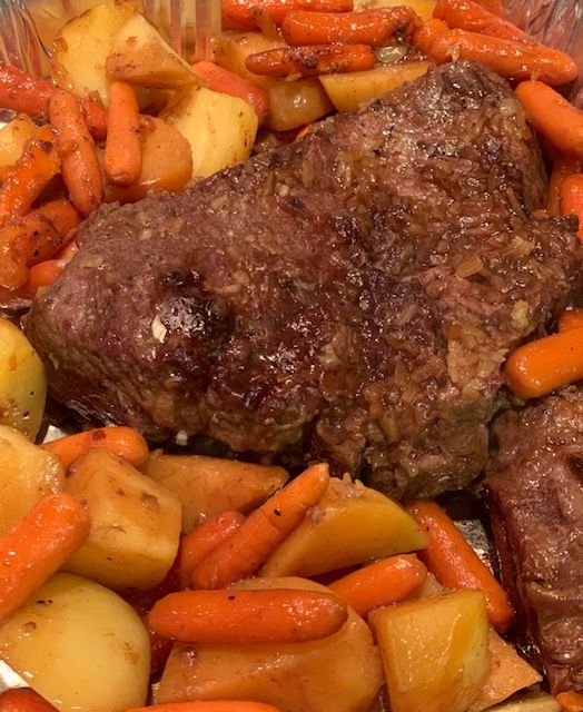 a close up of food on a plate with carrots and potatoes