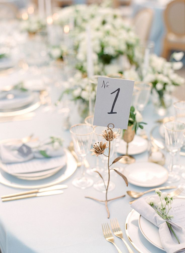 the table is set with place cards and silverware