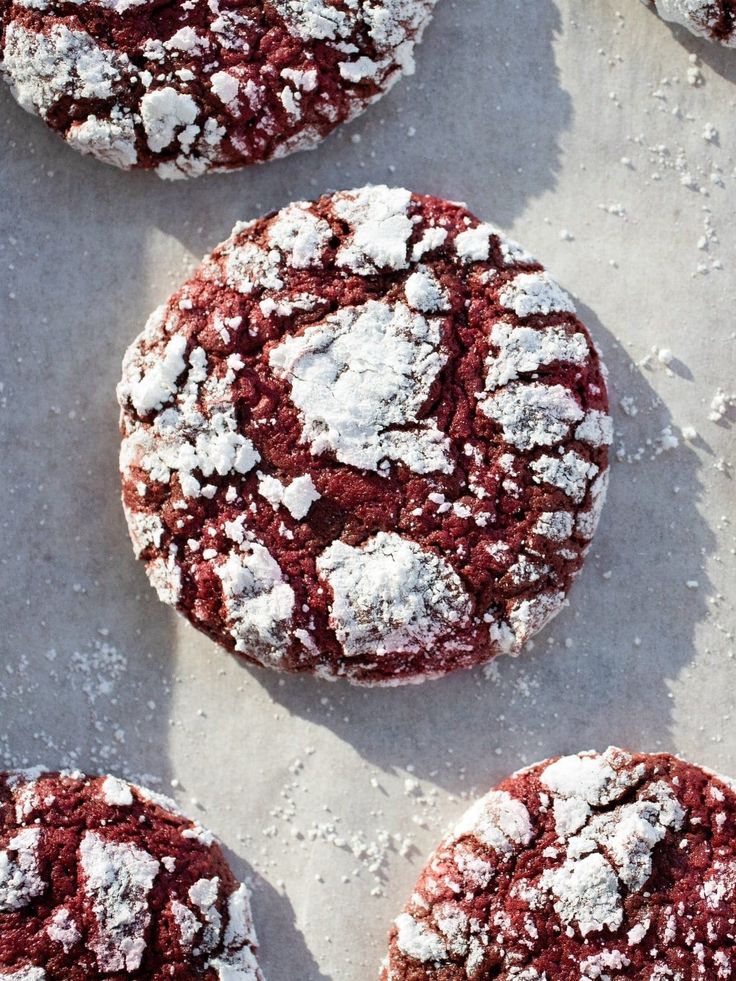 red velvet crinkle cookies with powdered sugar toppings on a baking sheet