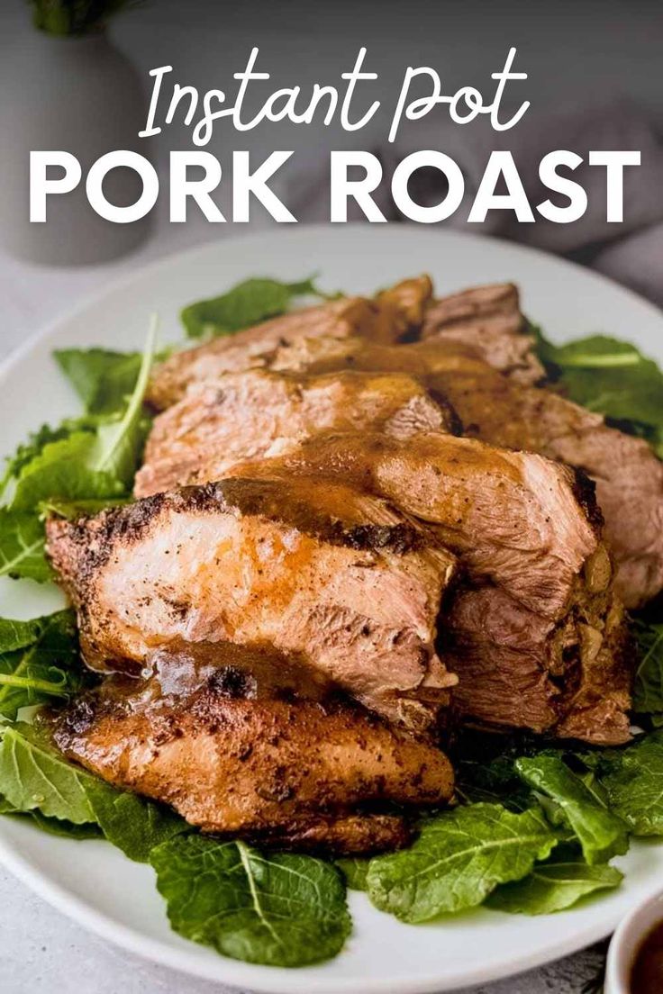 meat and greens on a white plate with sauce in a small bowl next to it