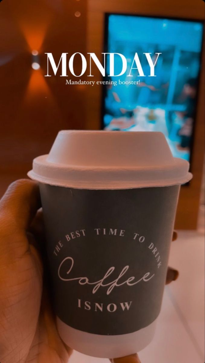 a person holding up a coffee cup with the words monday written in white on it