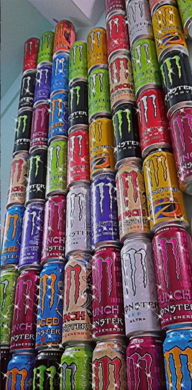 many cans of monster energy drink stacked on top of each other