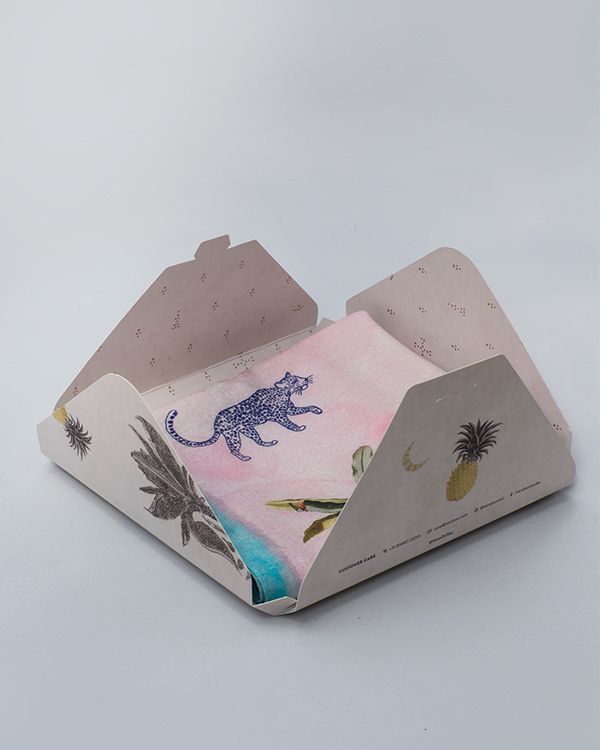 a paper box with an image of a cat and palm trees on the inside is shown