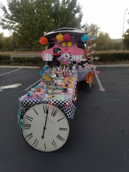 a table with a clock on it in the middle of a parking lot