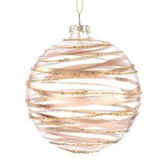 a glass ornament with gold and white stripes