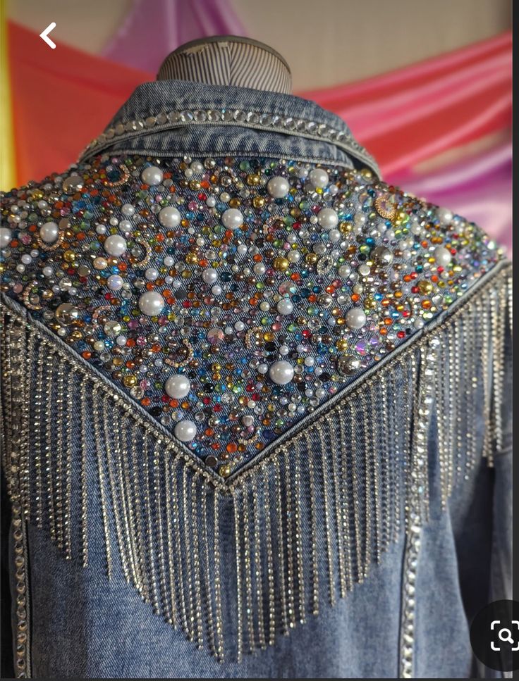 the back of a jacket with beads and chains on it