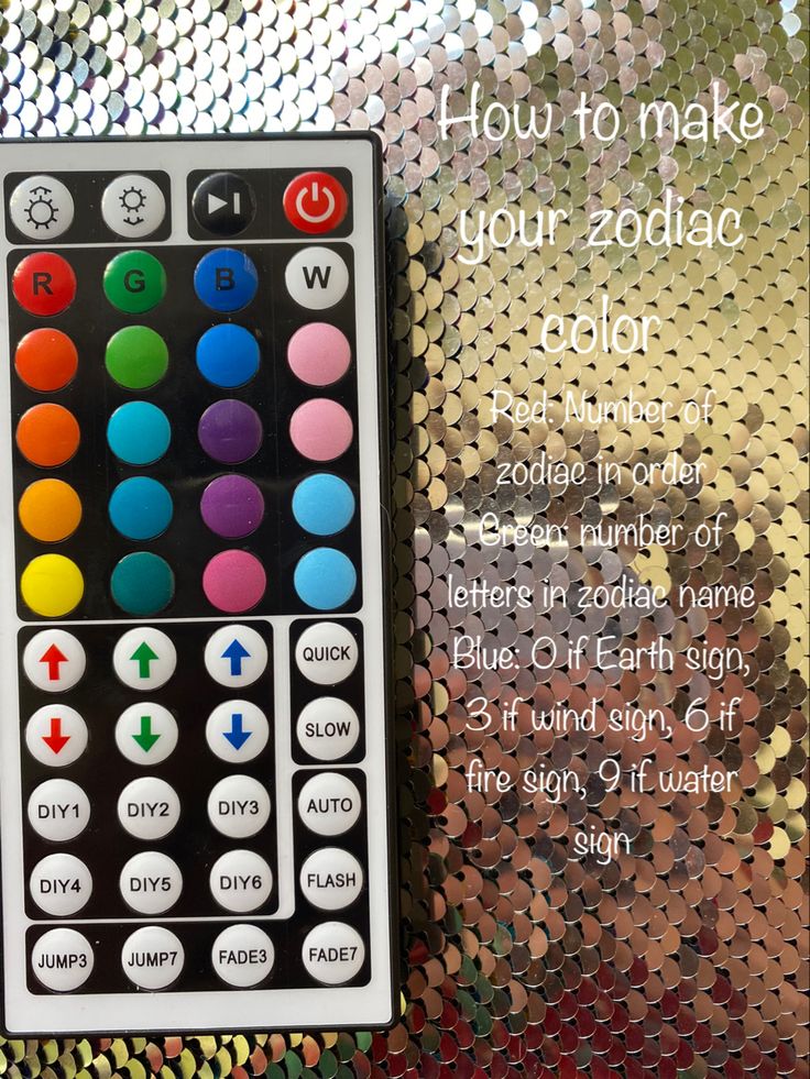 a close up of a remote control on a shiny surface with the words how to make your zodiac code