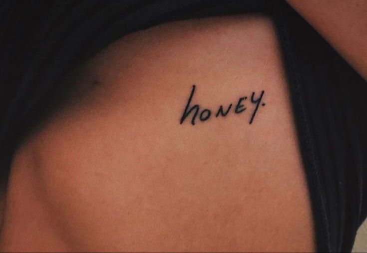 a woman's stomach with the word honey written in cursive font on it