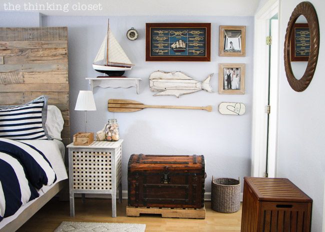 a bedroom with a bed, dresser and other items on the wall in front of it