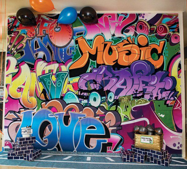 the wall is covered in graffiti and balloons