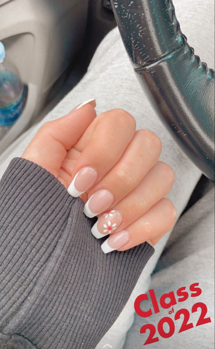 Cute French Tip Nails With Flowers, French Tip Nails With White Flowers, White Tip Nails With Design Spring, French Tip Acrylic Nails Coffin With Flowers, French Tip Acrylic Nails With Design White, Cool White French Tip Nails, Nail Art On Ring Finger, White Nails With French Tip Accent, White French Tip Nails With Accent Nail