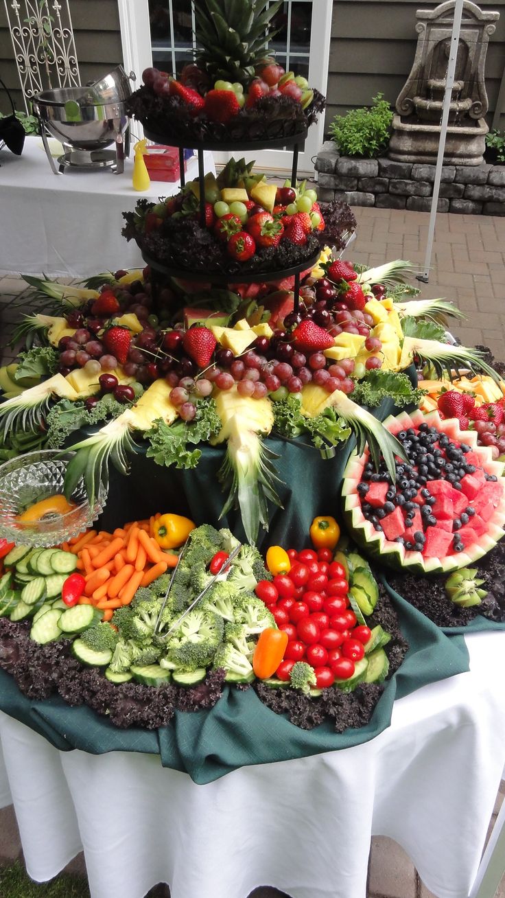 a table topped with lots of different types of fruits and vegetables on top of each other