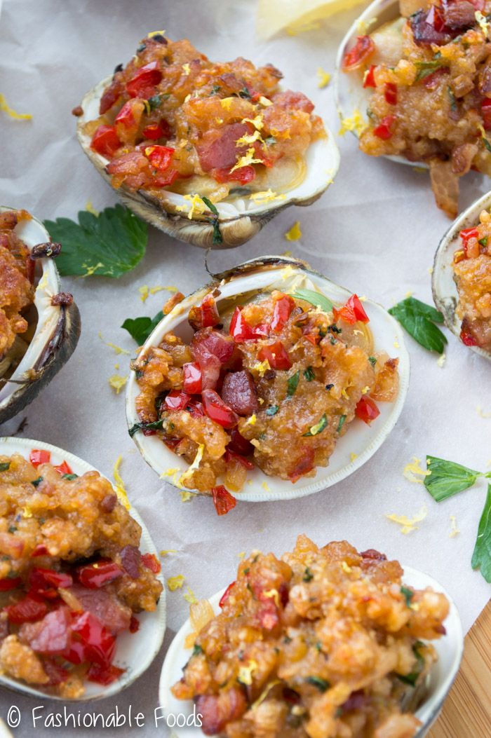 several open oysters with various toppings on them