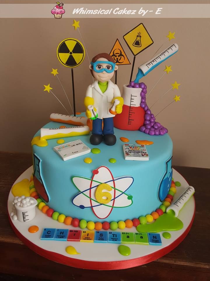 a birthday cake decorated with science themed items