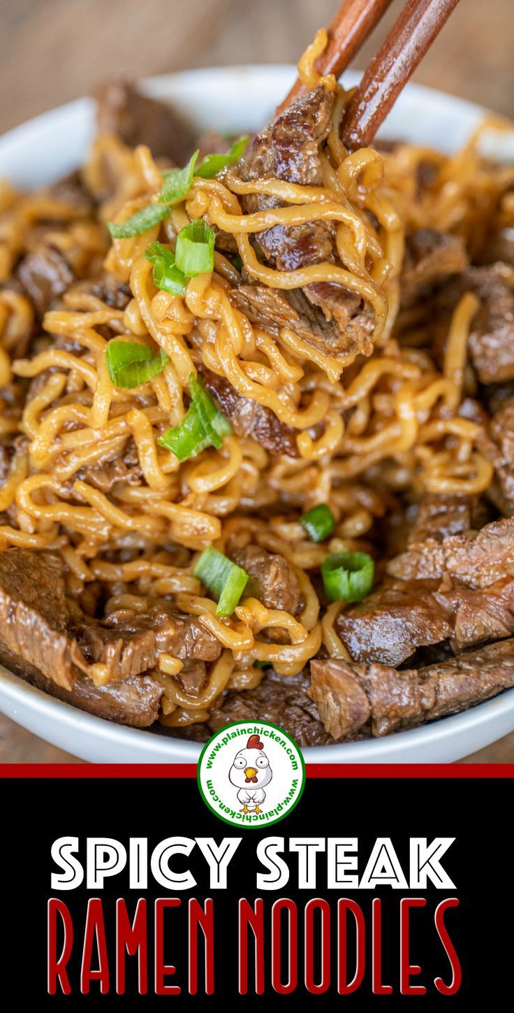 a bowl filled with beef and noodles on top of a wooden table next to chopsticks