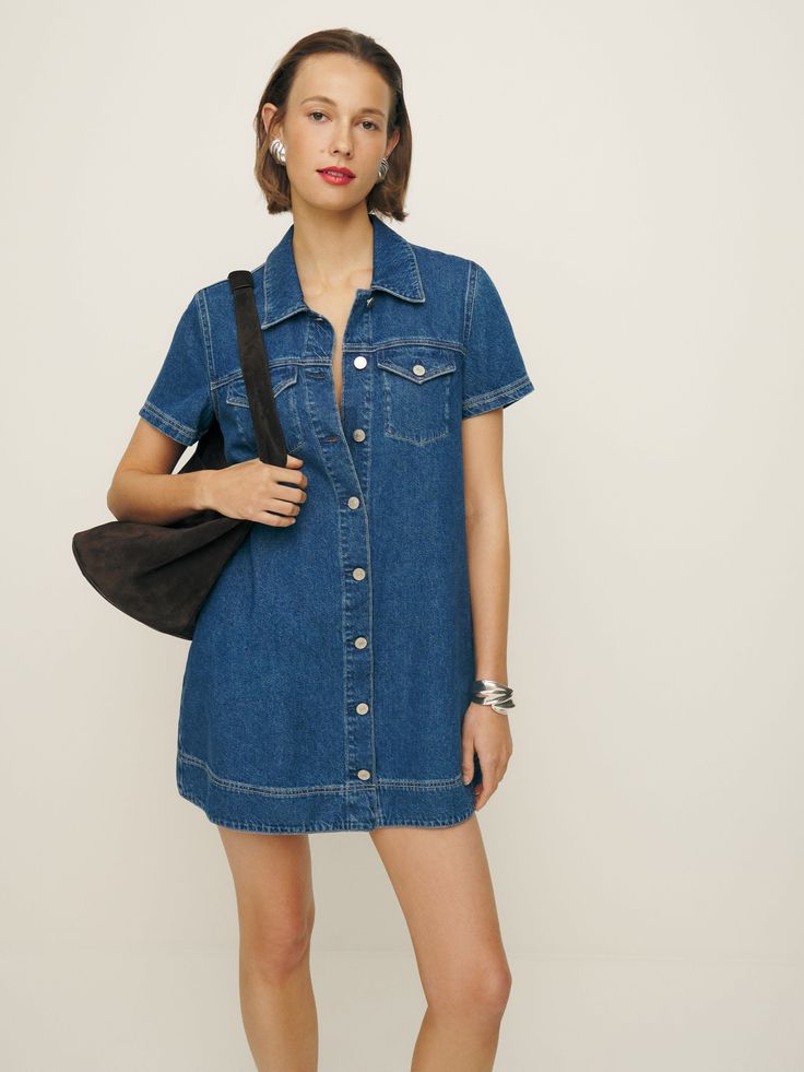 Denim time. Shop the Harlee Denim Mini Dress from Reformation, a mini-length dress with a collared neckline, button front, and short sleeves. Dark Denim Dress Outfit, Denim Babydoll Dress, Dark Wash Short Sleeve Dress With Buttons, Medium Wash Short Sleeve Mini Dress For Summer, Summer Mini Dress With Short Sleeves In Medium Wash, Short Sleeve Denim Dress For Day Out, Summer Denim Shirt Dress With Short Sleeves, Summer Short Sleeve Denim Shirt Dress, Denim Short Sleeve Dress With Buttons